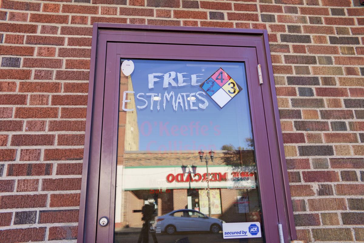 The shop door with Free Estimates painted on the glass