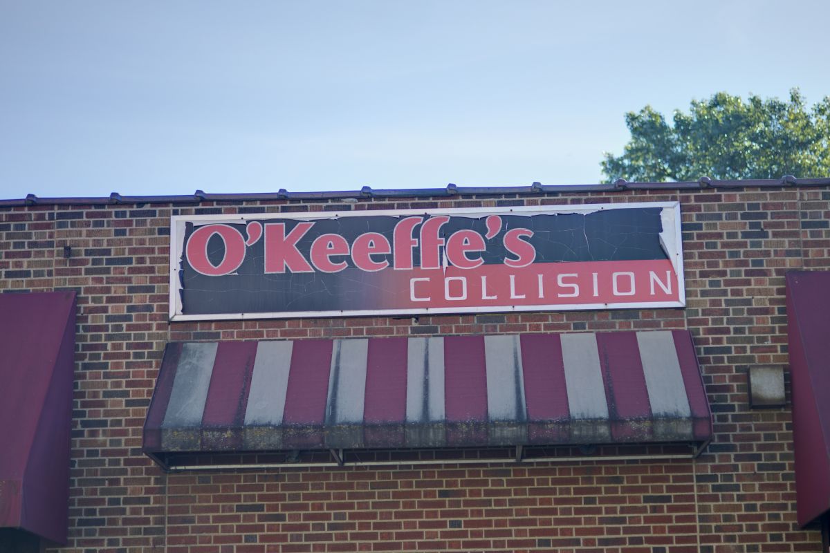 The O'Keeffe's Collision sign above the striped awning